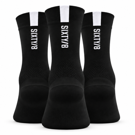 Three pairs of SIXTY/8 black cycling socks shown from the rear, featuring white vertical SIXTY/8 logos and white cuff detailing
