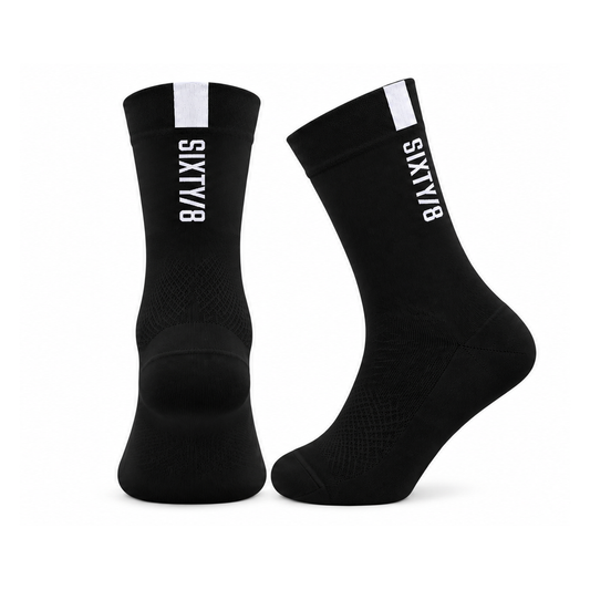 Rear and side views of SIXTY/8 black cycling socks with white vertical branding and white cuff detailing.