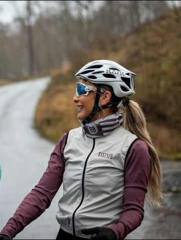 Woman cyclist outdoors wearing SIXTY/8 Heather/Stone striped cycling neck warmer with helmet and cycling jacket