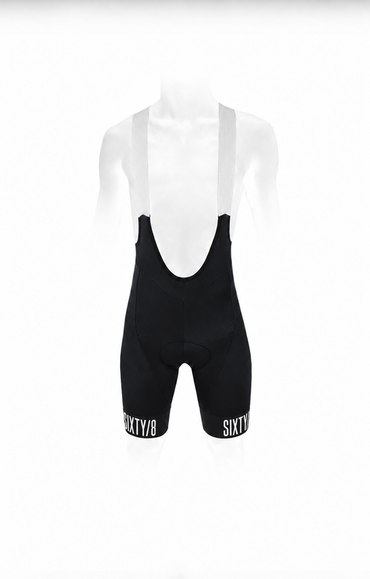 SIXTY/8 men's black cycling bib shorts, front view showing white bib straps and white SIXTY/8 branding on the leg cuffs.