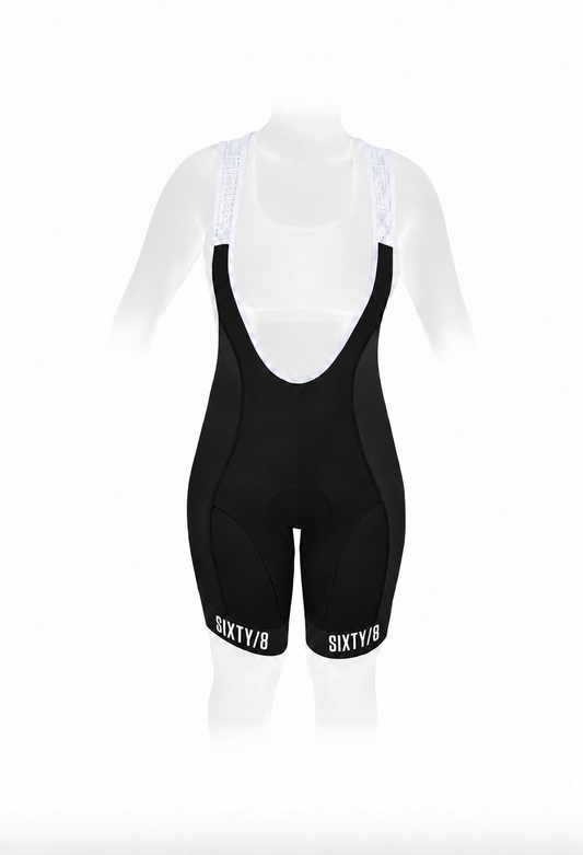 Front view of SIXTY/8 women's black padded cycling bib shorts with white mesh shoulder straps and white SIXTY/8 logos on both leg cuffs.
